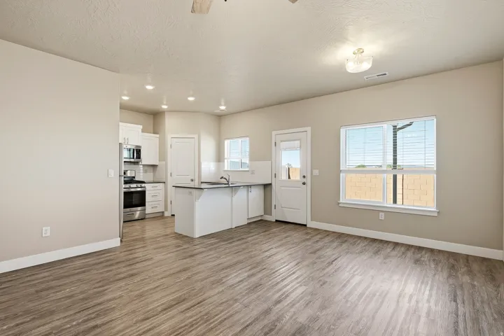 Open-concept living space featuring wood-finish flooring, recessed lighting, and neutral wall tones