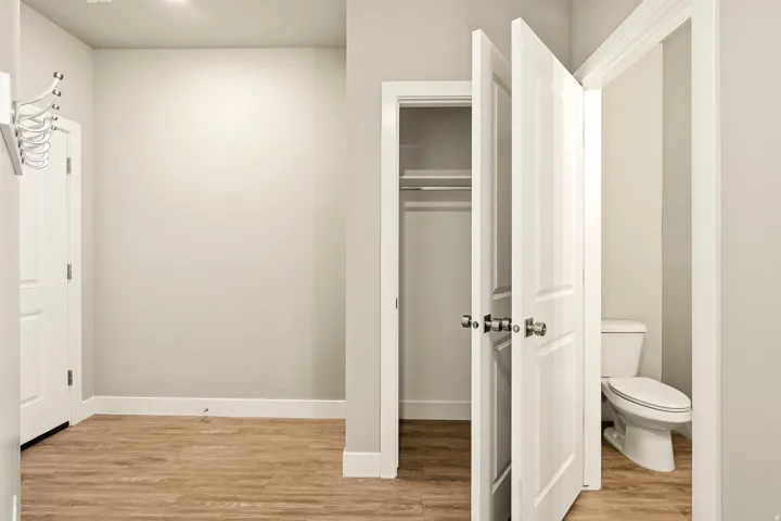 Interior area featuring wood-finish flooring, white baseboards, and light gray walls