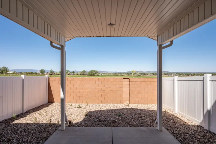 Covered patio featuring a concrete slab and a gravel surround