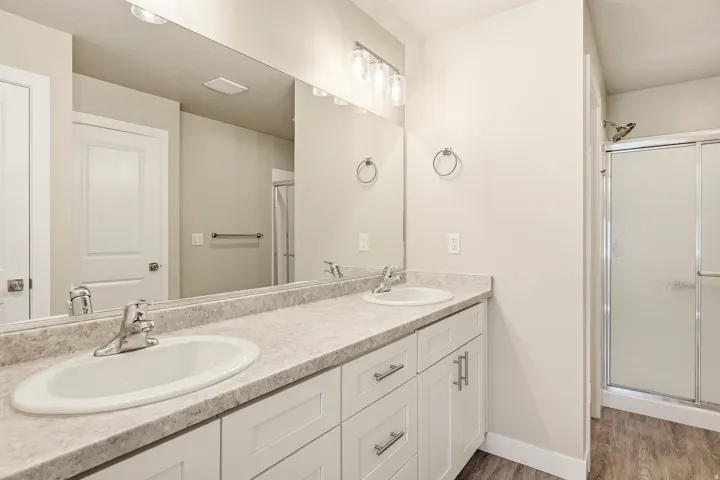 Double vanity with two undermount sinks and chrome fixtures