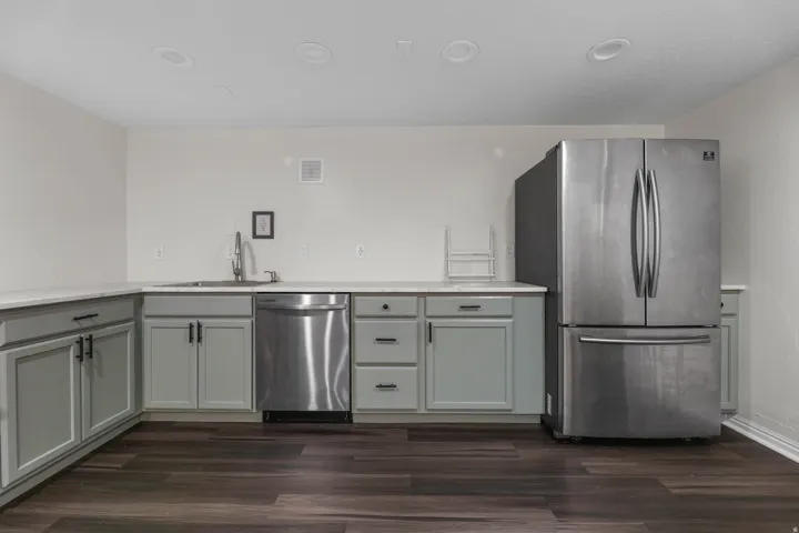 Kitchen / Break Room featuring ample cabinet and countertop space, sink, dishwasher and stove. Located in the bsmt of the North Bldg