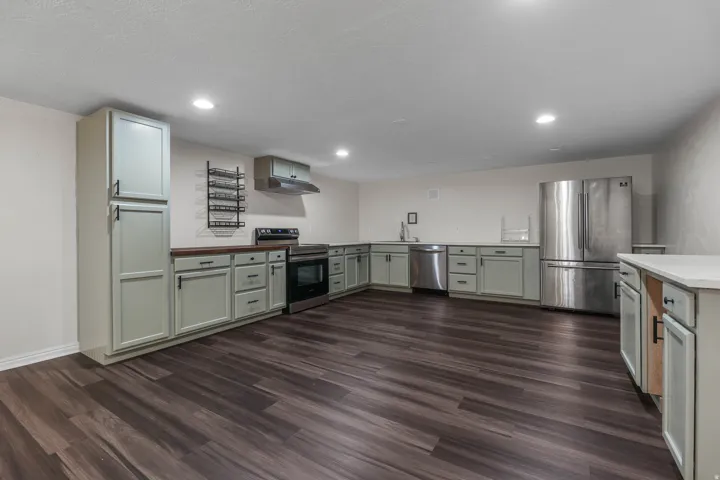 Kitchen / Break Room featuring ample cabinet and countertop space, sink, dishwasher and stove. Located in the bsmt of the North Bldg