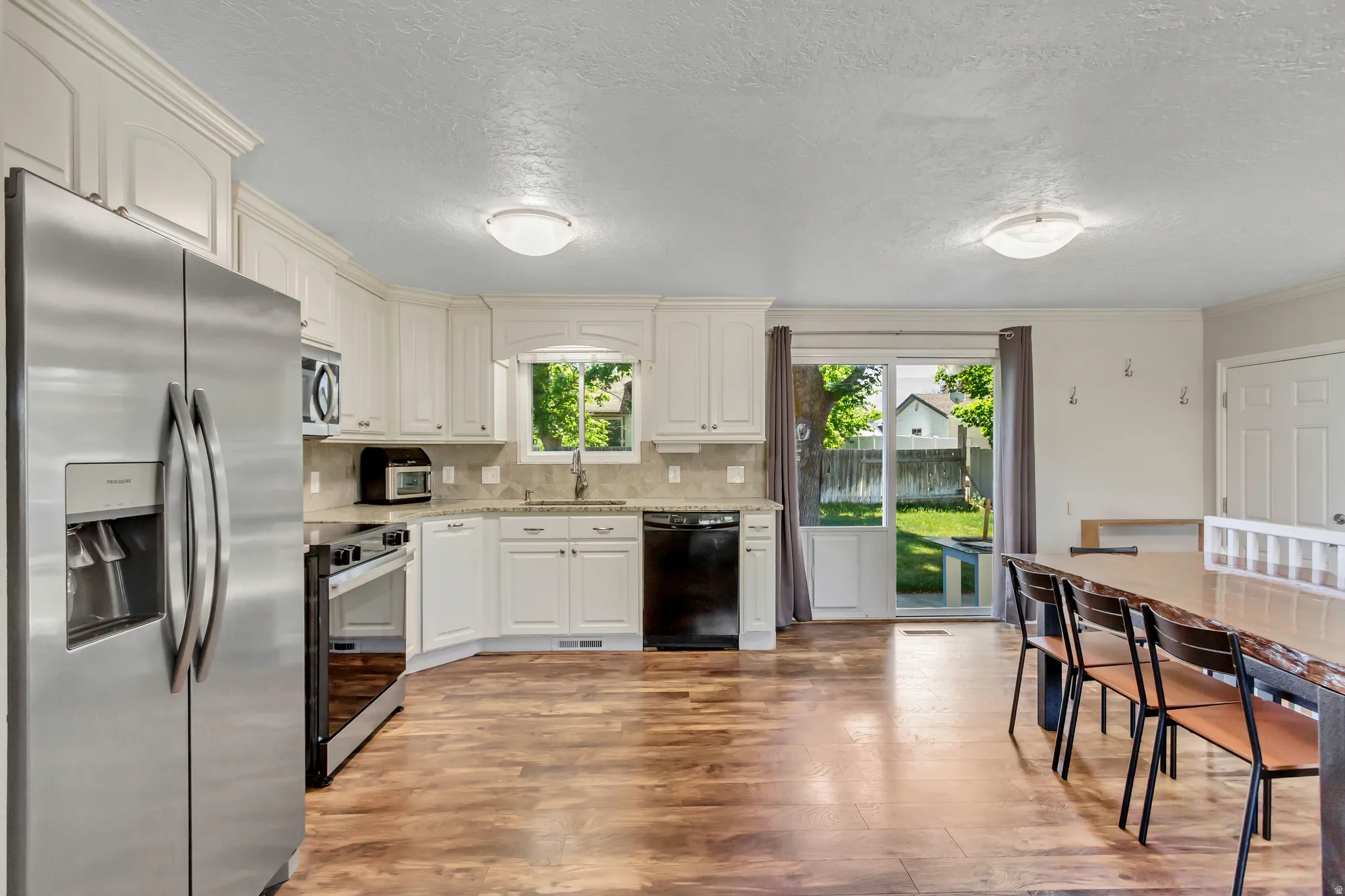 Kitchen and dining area featuring wood-finish flooring