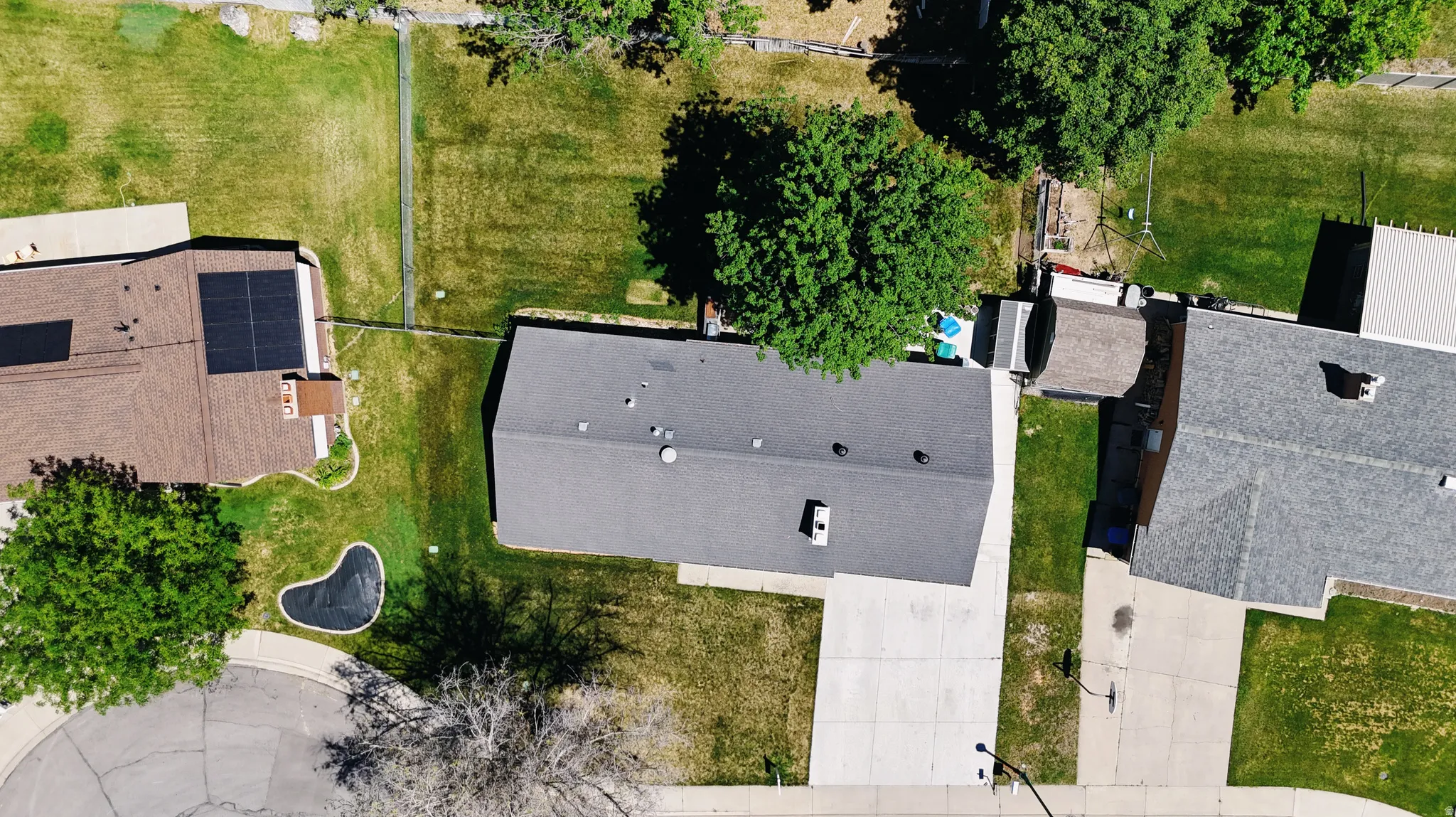Overhead view of a residential property with a gray asphalt shingle roof
