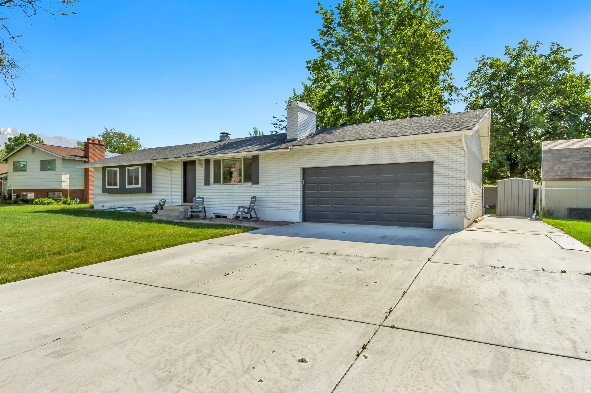 White brick exterior with a dark gray garage door