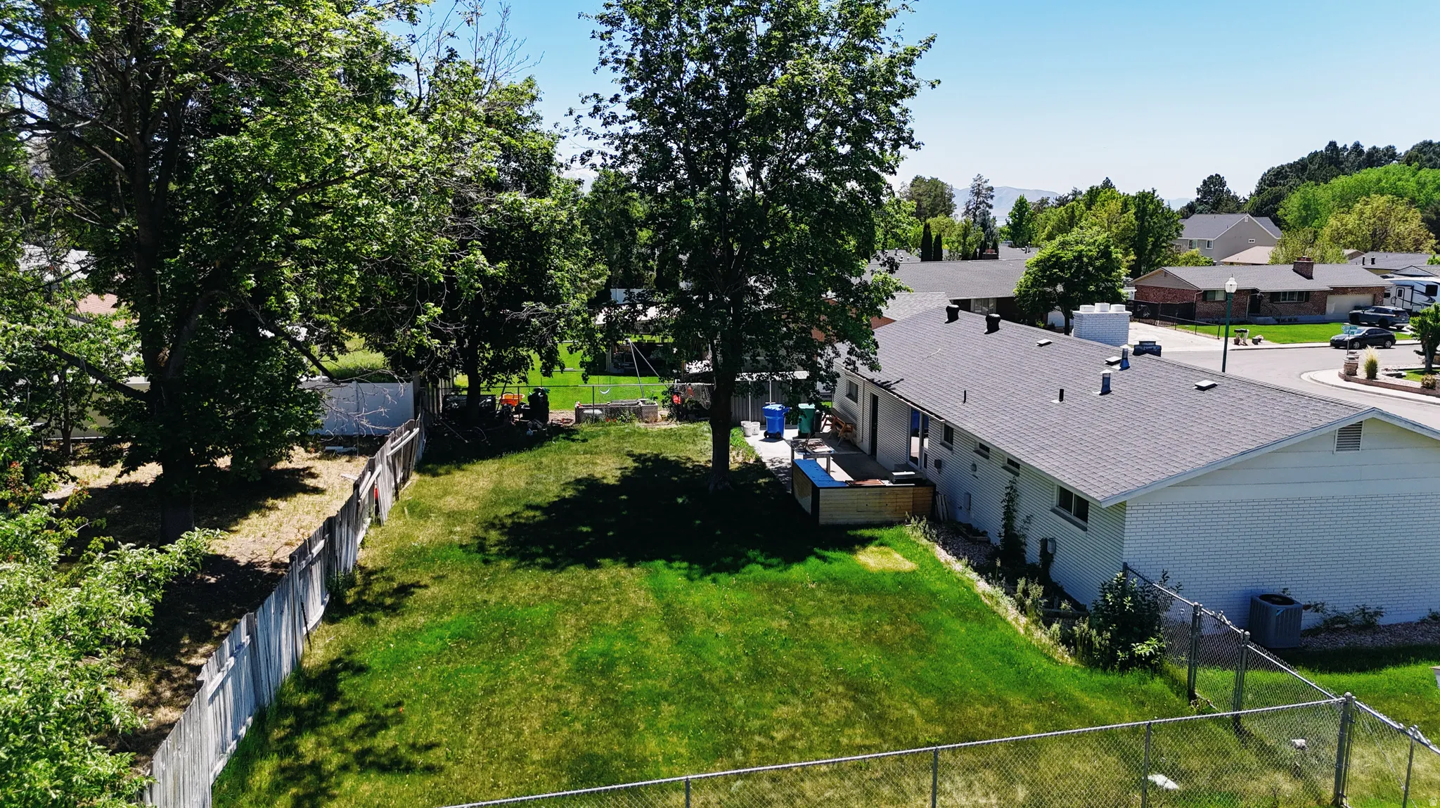 Expansive grassy yard with mature trees