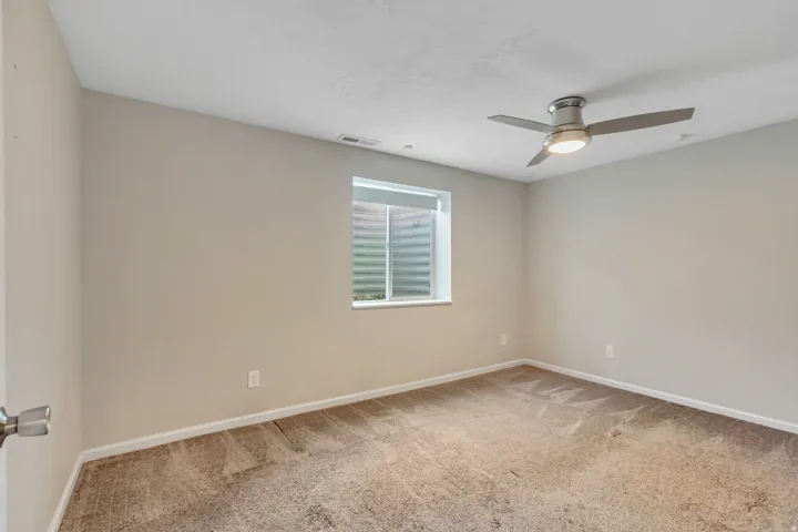 Neutral-toned wall paint with a window featuring a window well