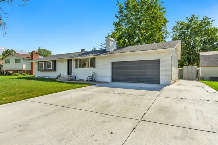 White brick exterior with a dark gray garage door