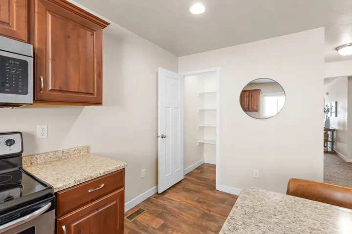 Kitchen featuring wood-finish flooring, recessed lighting, and a pantry with built-in shelving