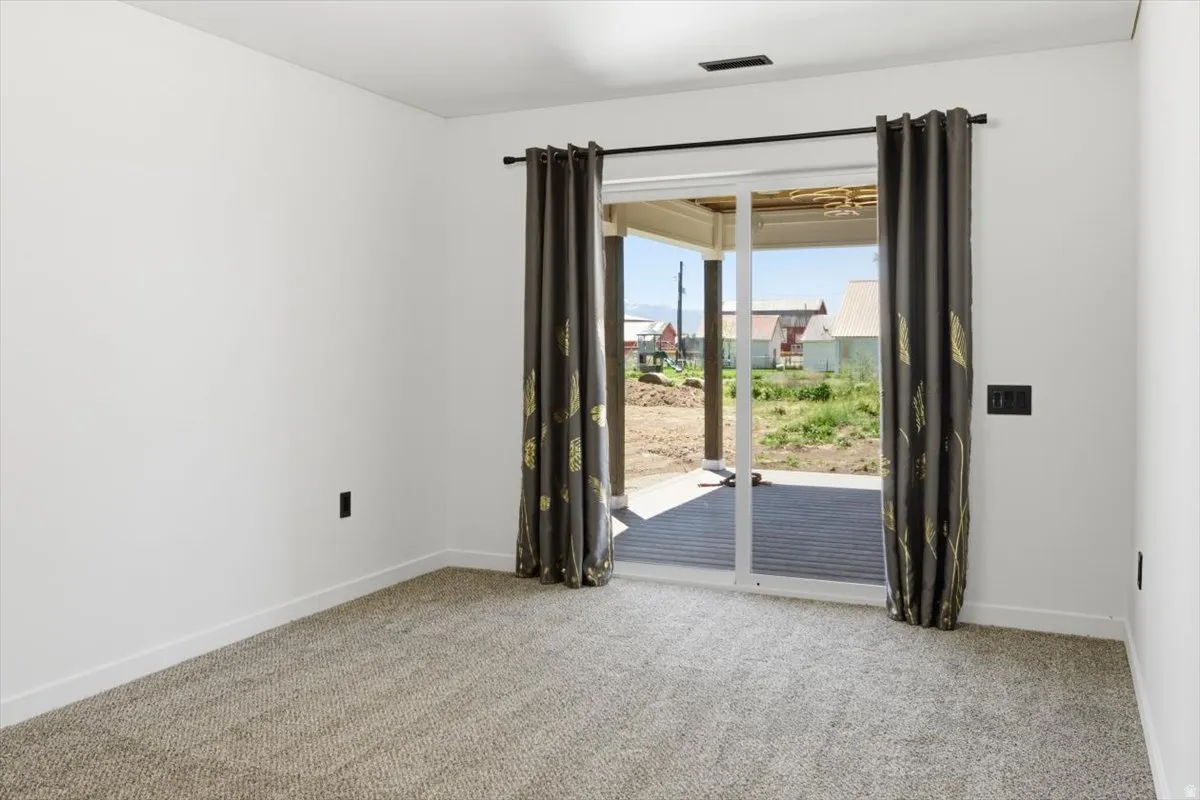 Room featuring light-colored walls and neutral-toned carpeting