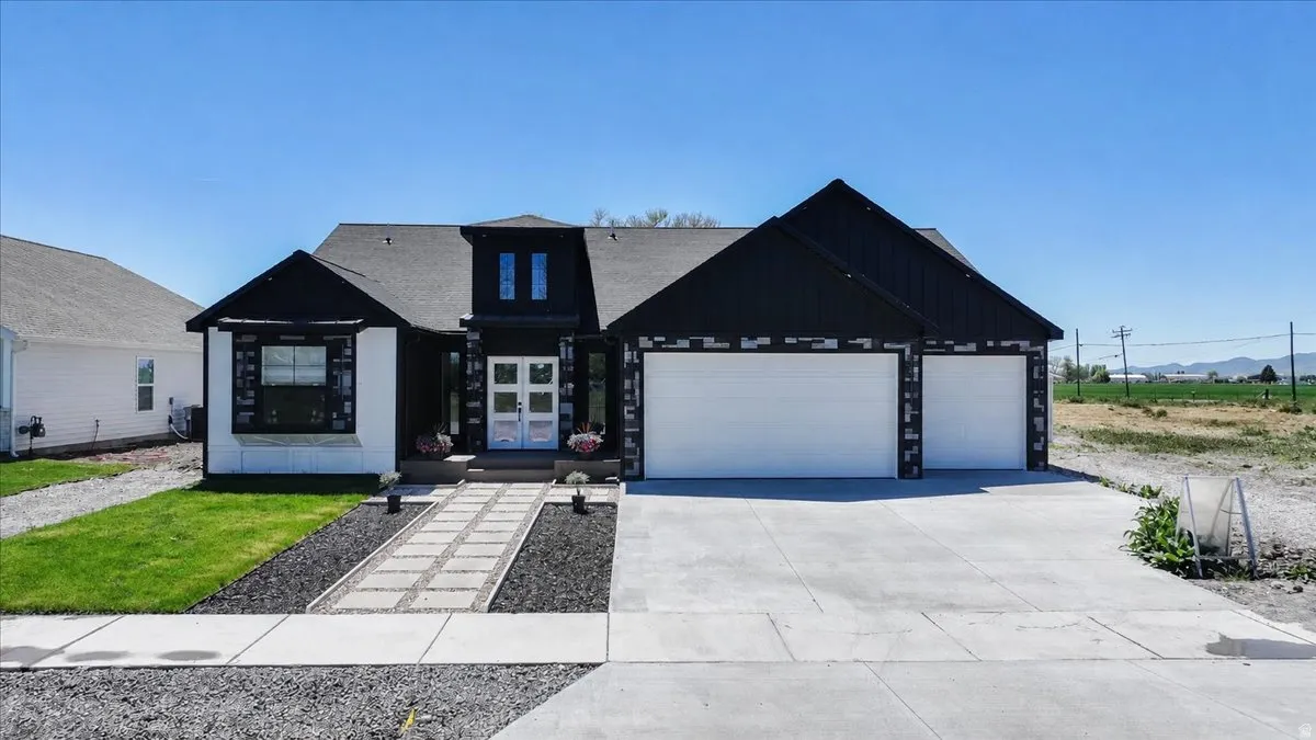 Modern exterior with contrasting black siding and white stucco accents