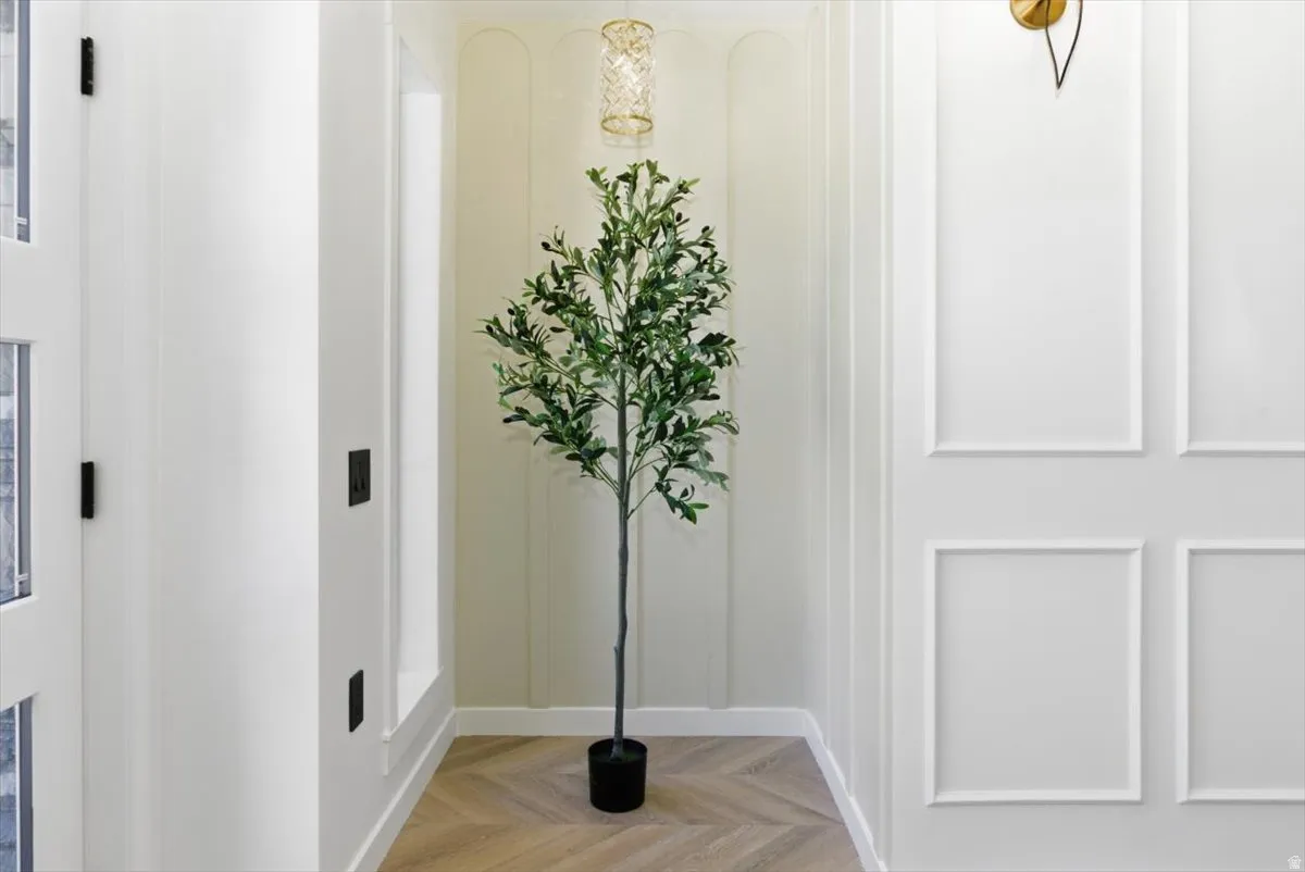 Herringbone wood-finish flooring complements panel molding wall features