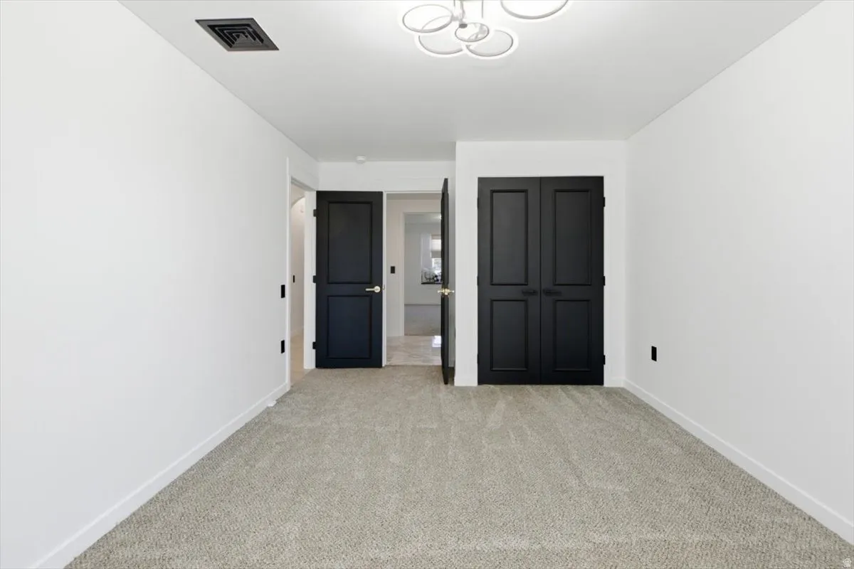 Neutral-toned carpeting paired with crisp white walls