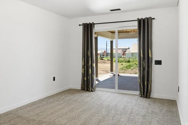 Room featuring light-colored walls and neutral-toned carpeting