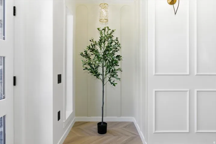 Herringbone wood-finish flooring complements panel molding wall features