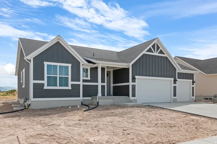 Contemporary ranch-style residence featuring dark gray vertical and horizontal siding with white trim