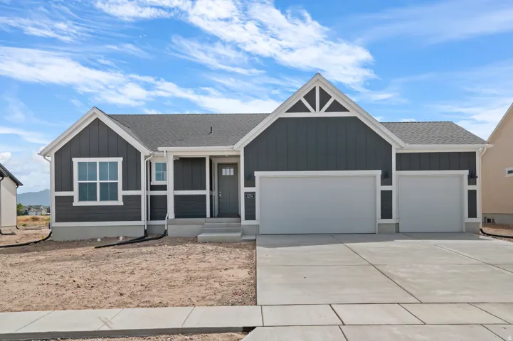 Contemporary ranch-style exterior featuring dark vertical and horizontal siding with white trim