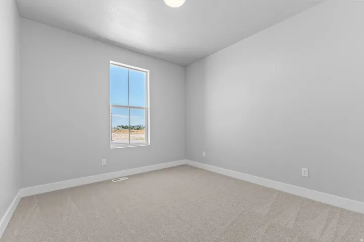 Neutral-toned carpeting paired with white baseboards