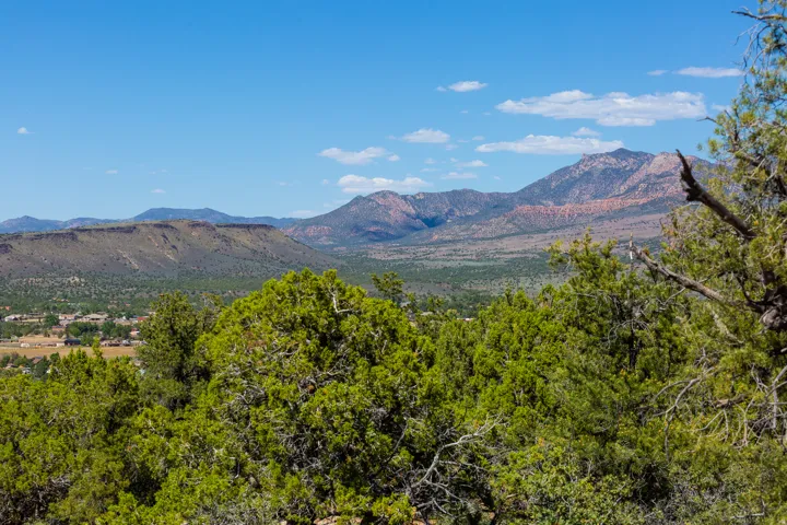 Expansive mountain backdrop with distant residential structures