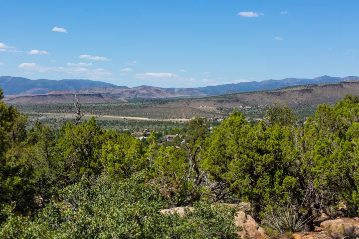 Expansive mountain and valley scenery featuring abundant natural vegetation