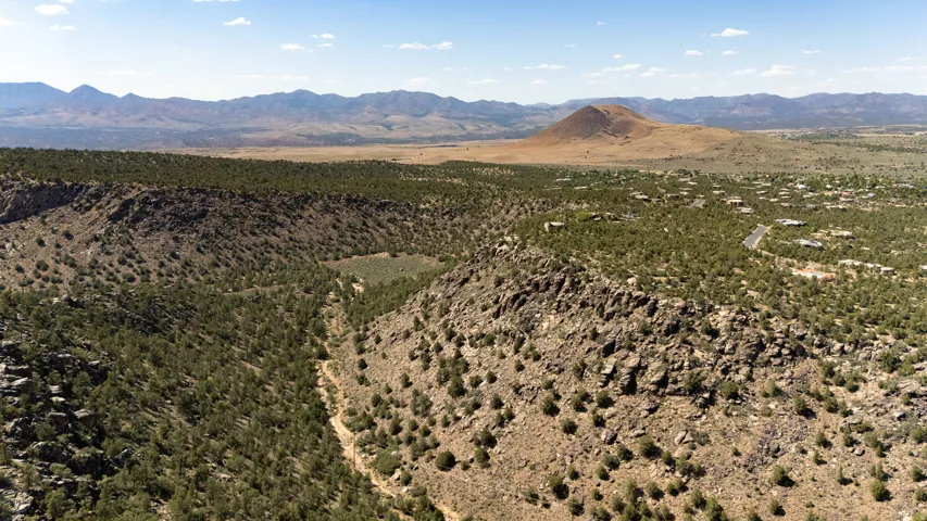 Expansive desert landscape featuring rugged terrain and verdant vegetation