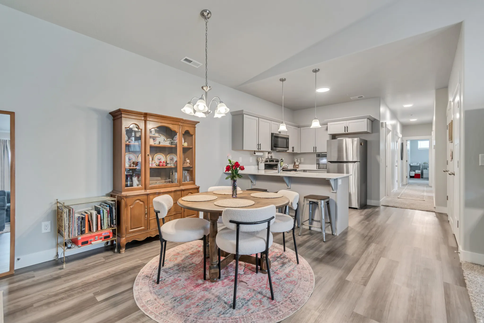 Open-concept living space featuring wood-finish flooring, recessed lighting, and a neutral wall color