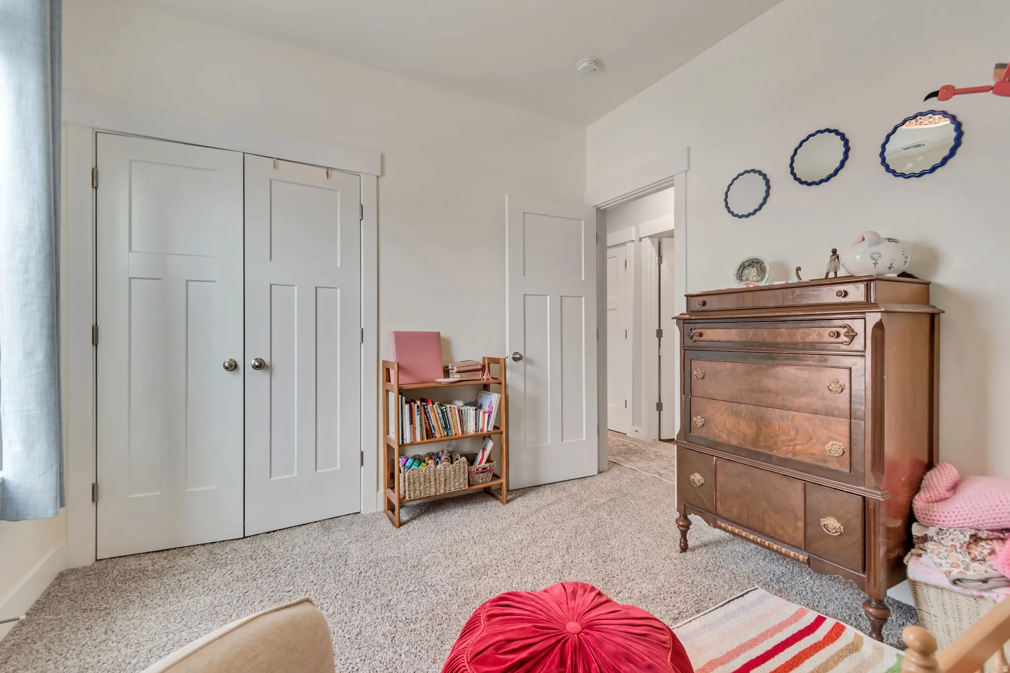 Light-colored wall-to-wall carpeting complements the neutral wall color