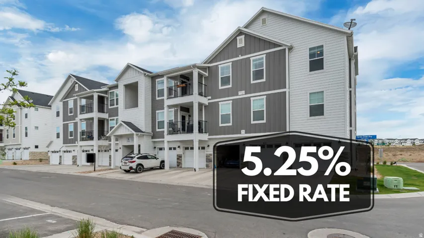 Multi-story residential complex featuring contemporary siding, individual balconies with black railings, and integrated ground-level garages
