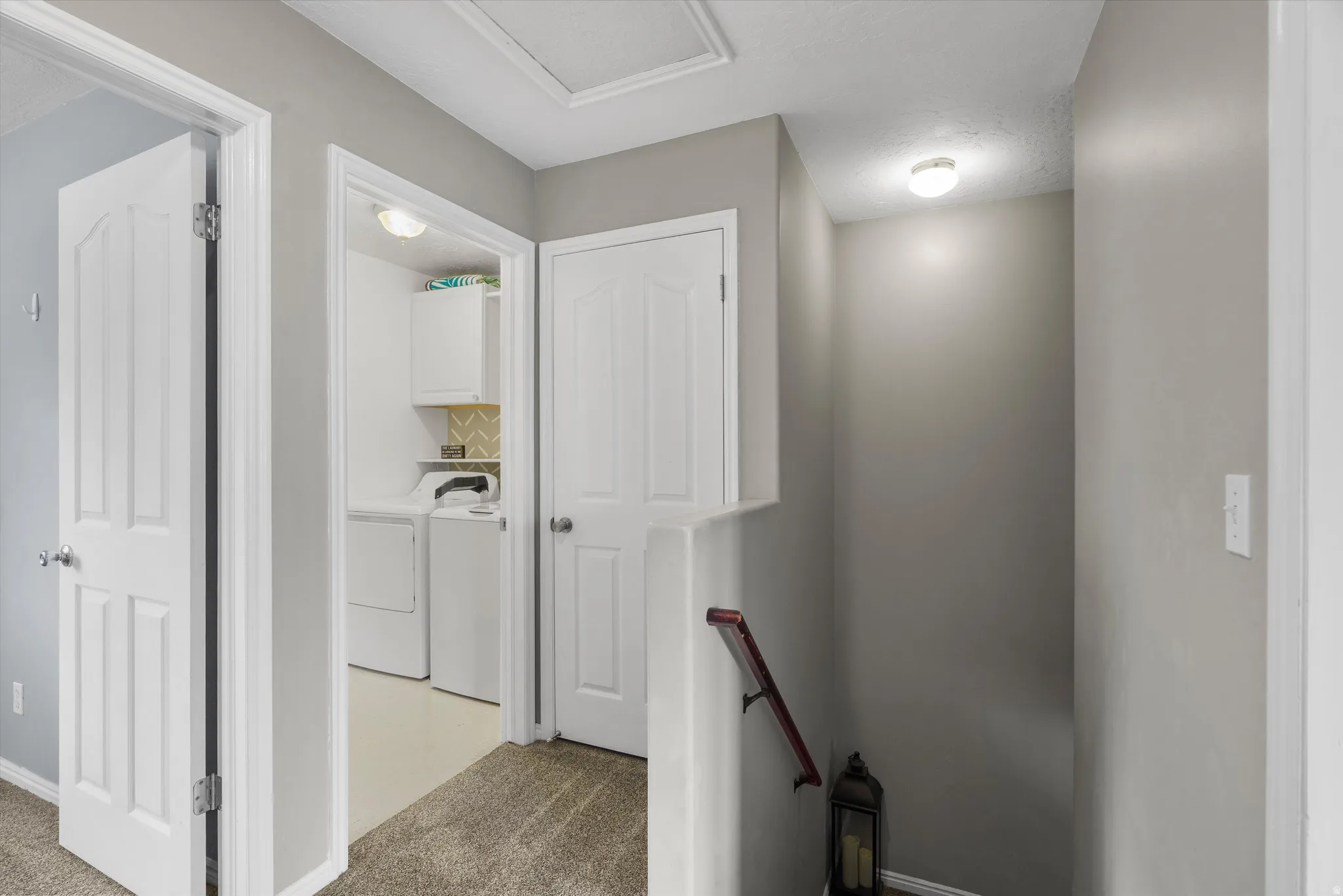 Dedicated laundry area featuring white cabinetry
