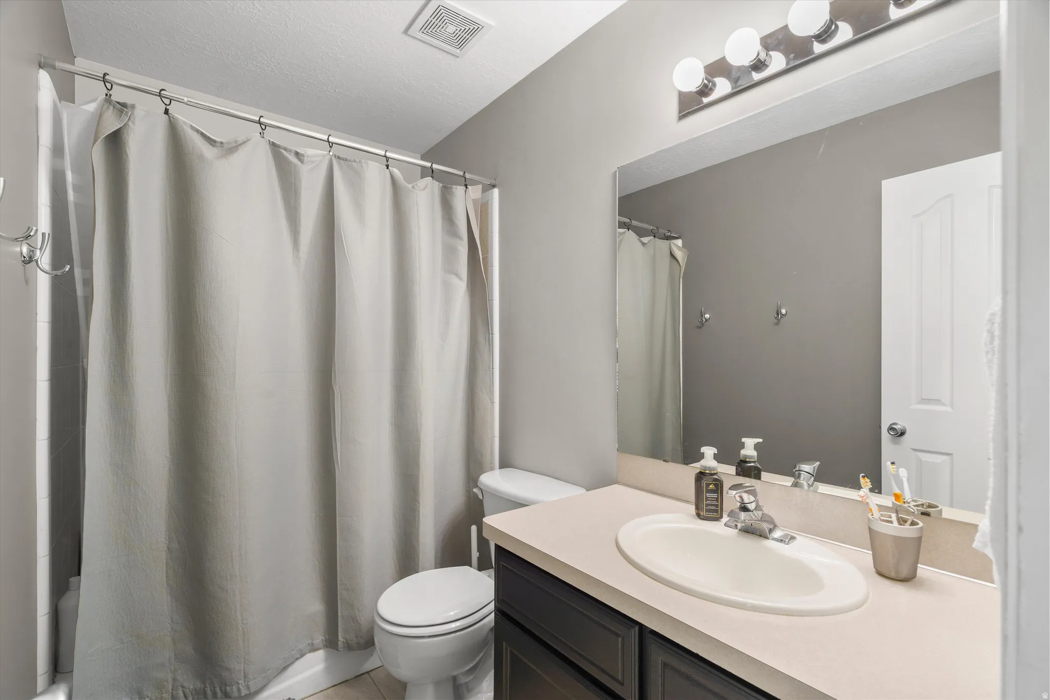 Full bathroom with tile flooring