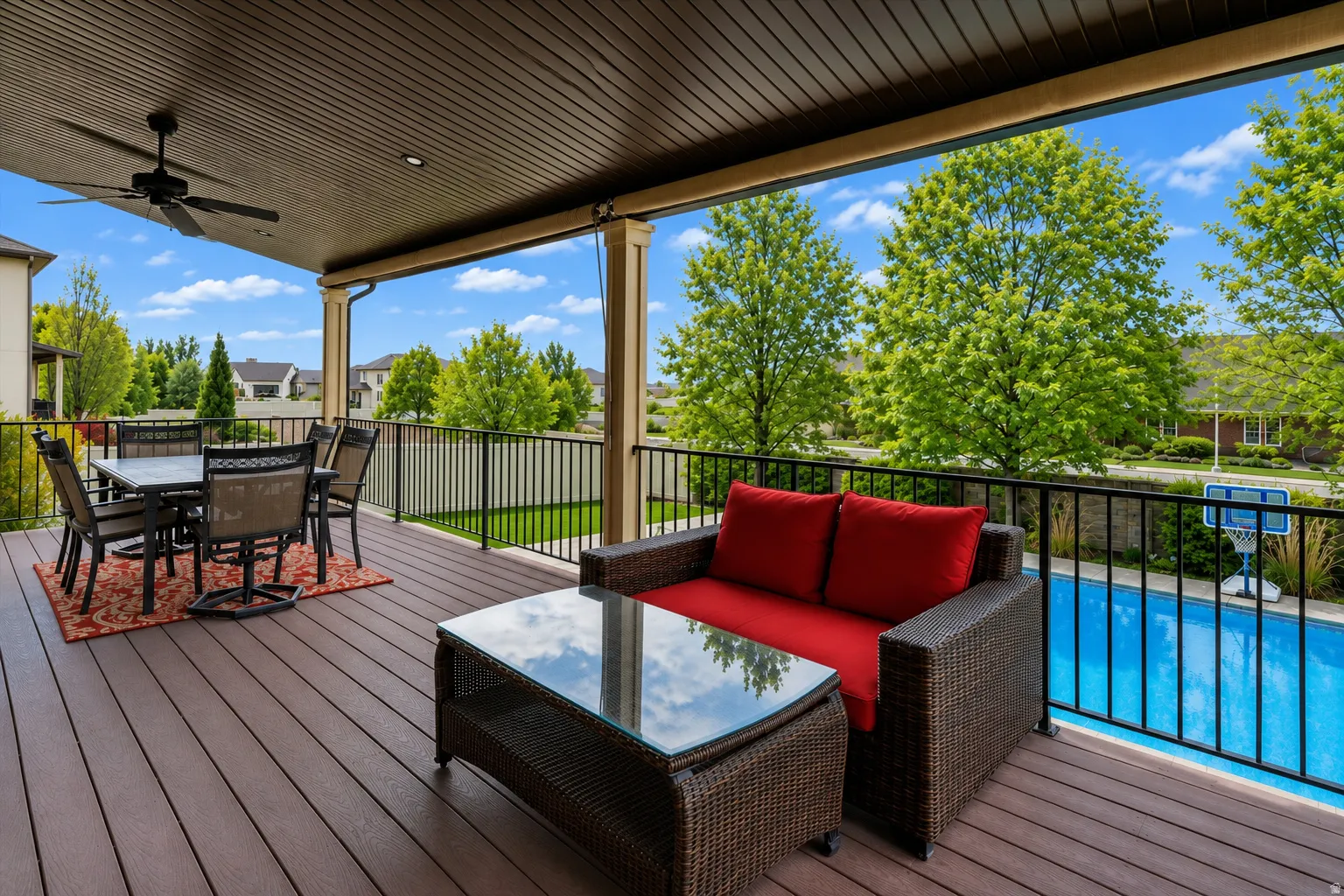 Covered outdoor deck with composite decking, recessed lighting, and a ceiling fan