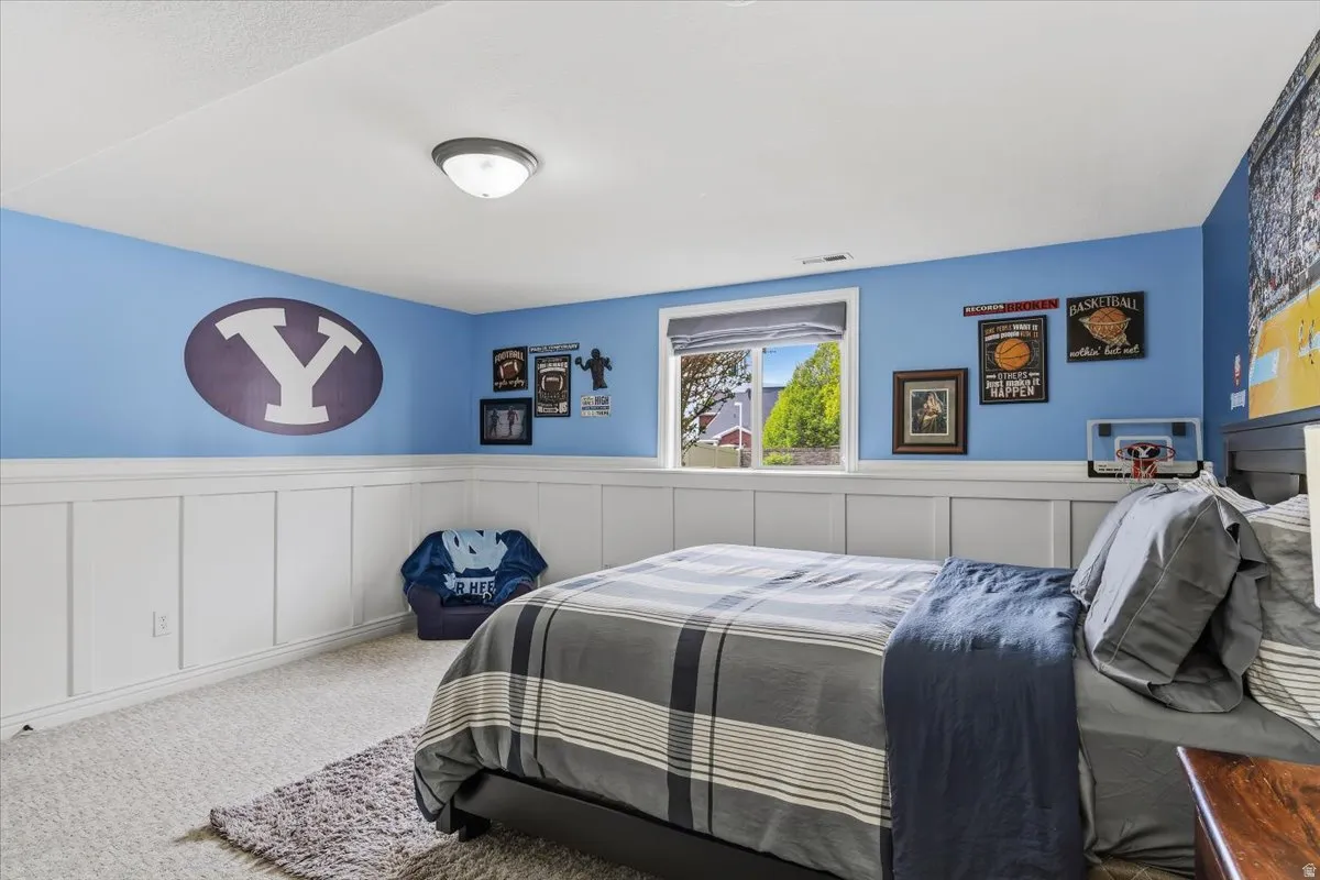 Room featuring wainscoting and light blue painted walls