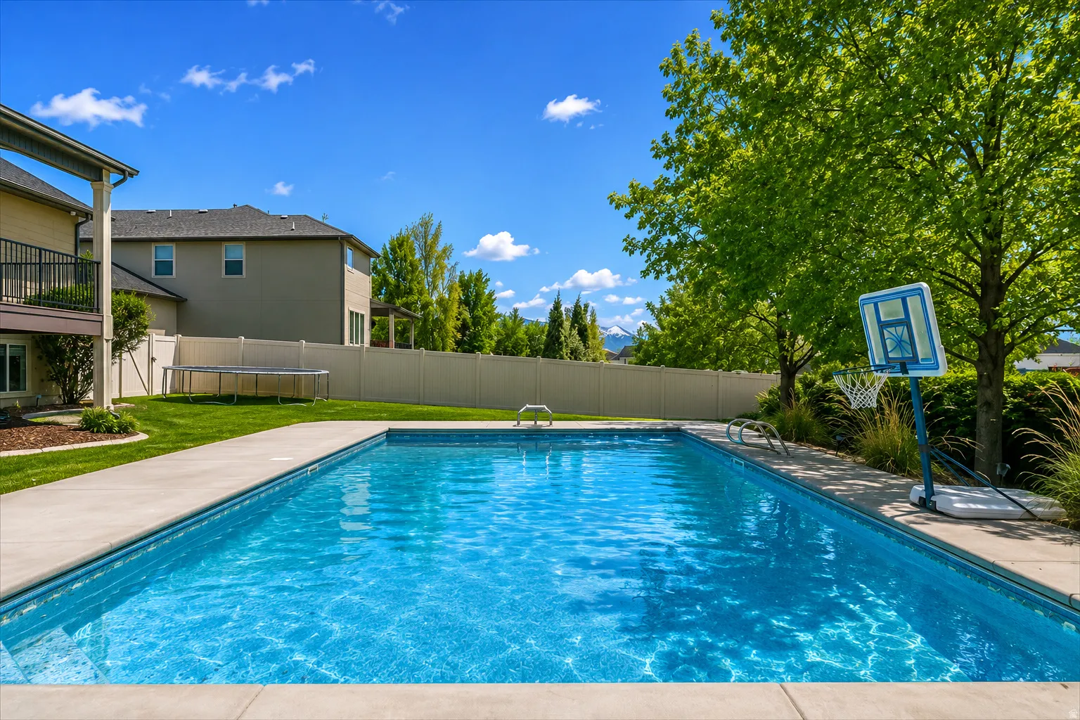 In-ground swimming pool featuring a concrete surround