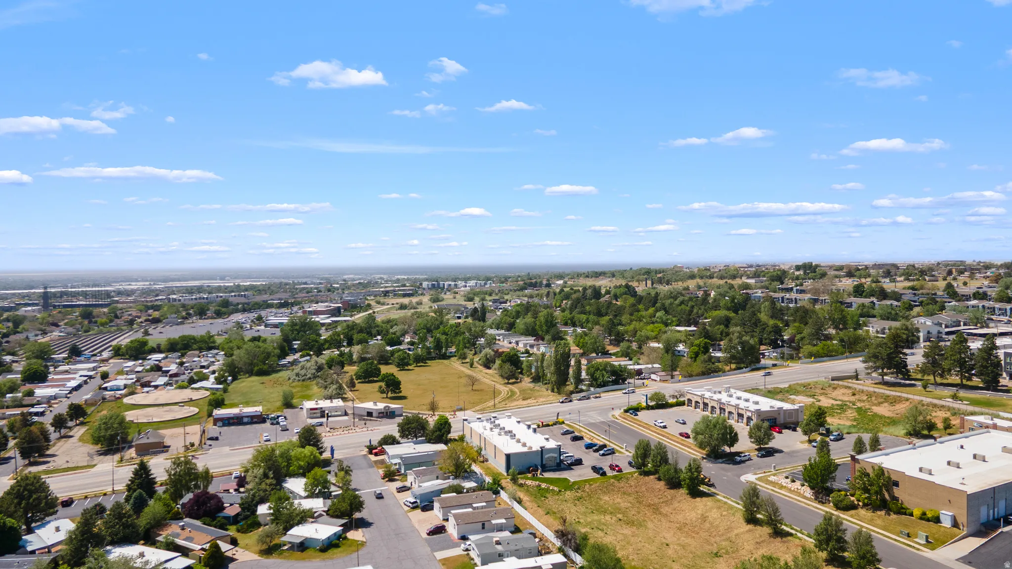 Expansive aerial perspective showcasing a developed urban landscape with various residential and commercial structures