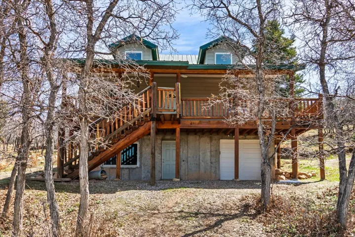 single car garage, stairs leading to the deck. This is the west side view of the cabin.
