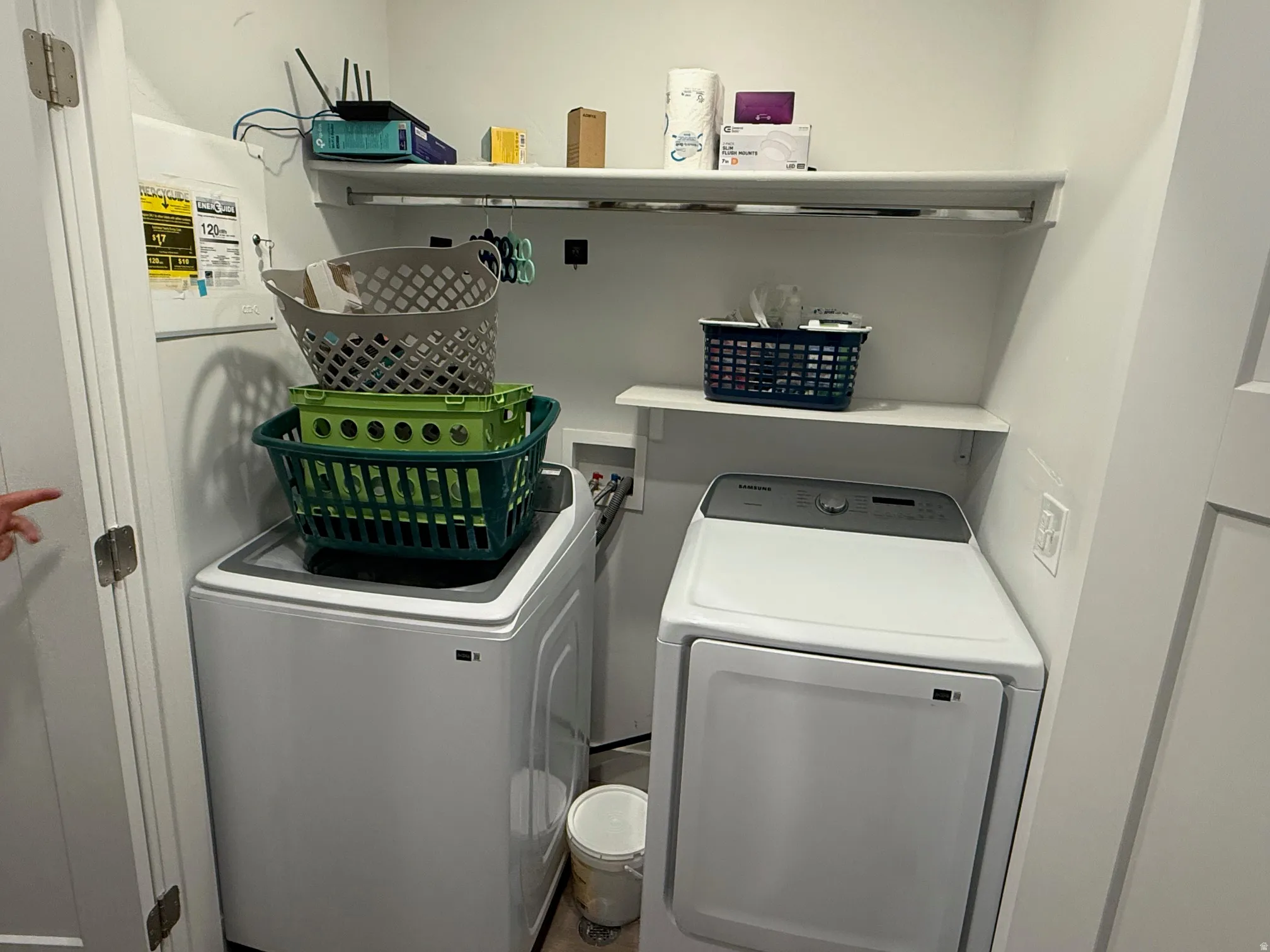 Dedicated laundry area featuring a white top-load washing machine and a white front-load dryer