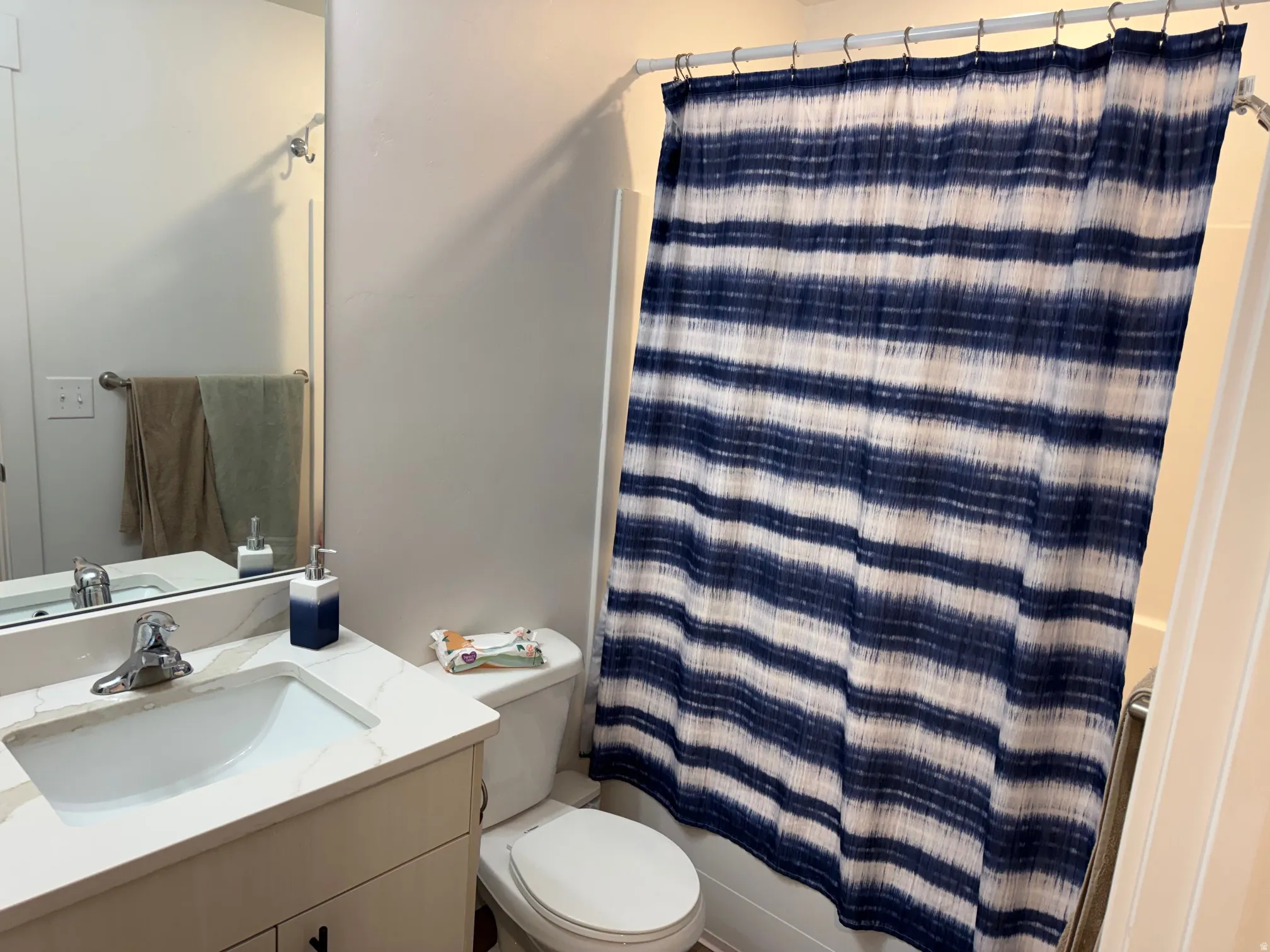 Bathroom featuring a built-in vanity with a white countertop and integrated sink