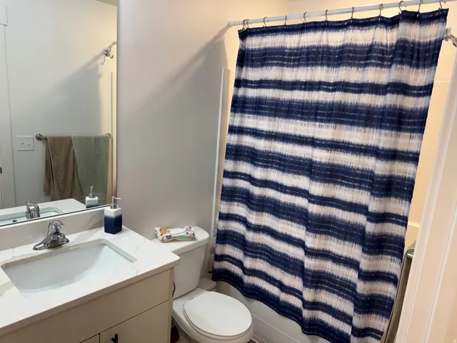 Bathroom featuring a built-in vanity with a white countertop and integrated sink