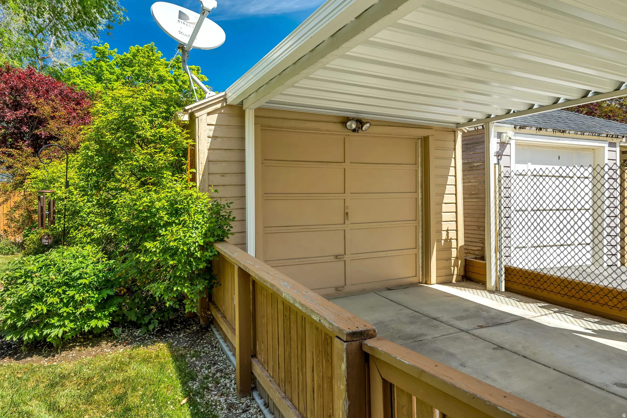 Carport with a corrugated metal roof providing covered parking