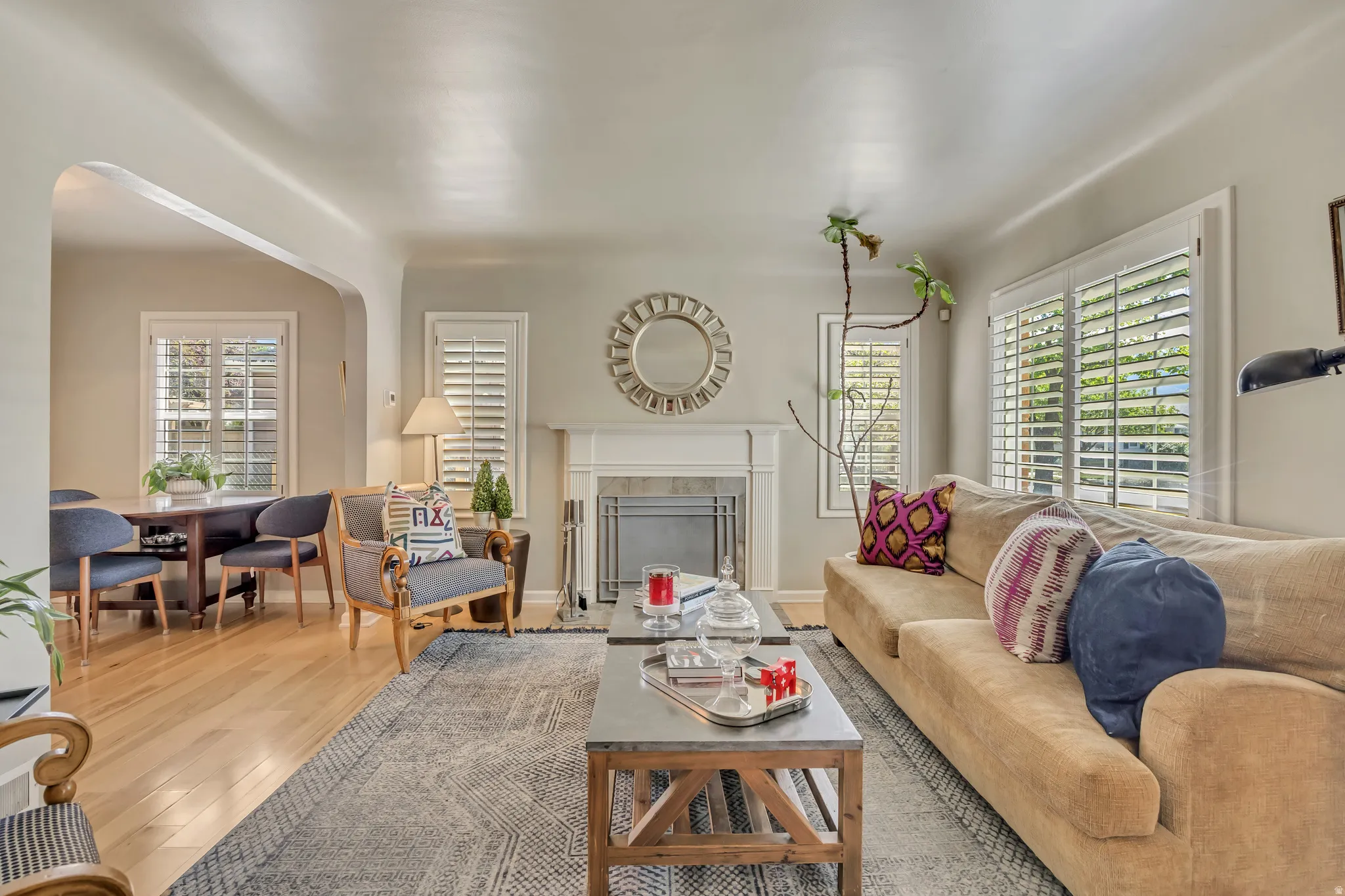 Living area featuring a white fireplace with a decorative mantel and hearth