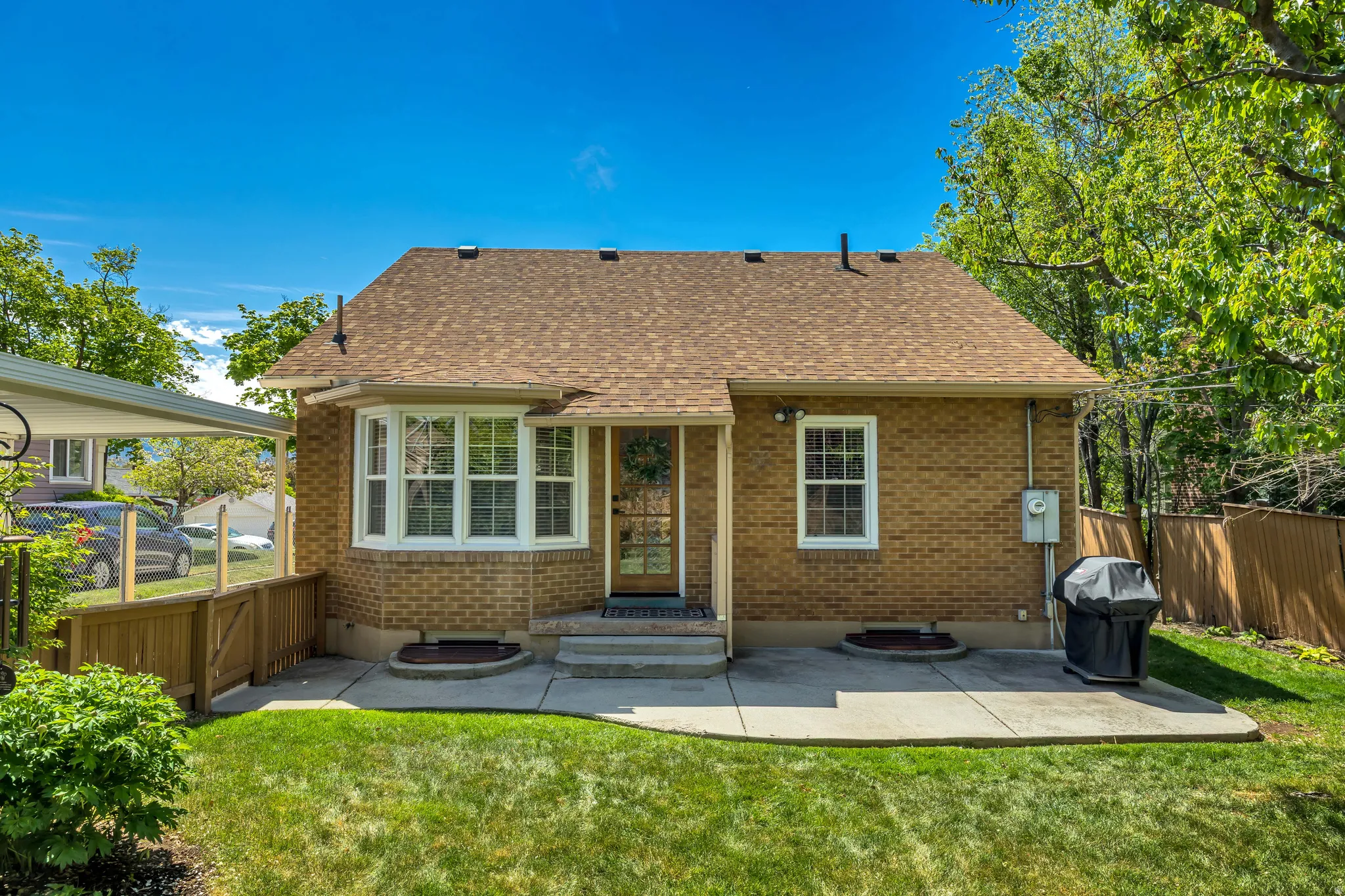 Brick exterior with a classic bay window and a covered front entry