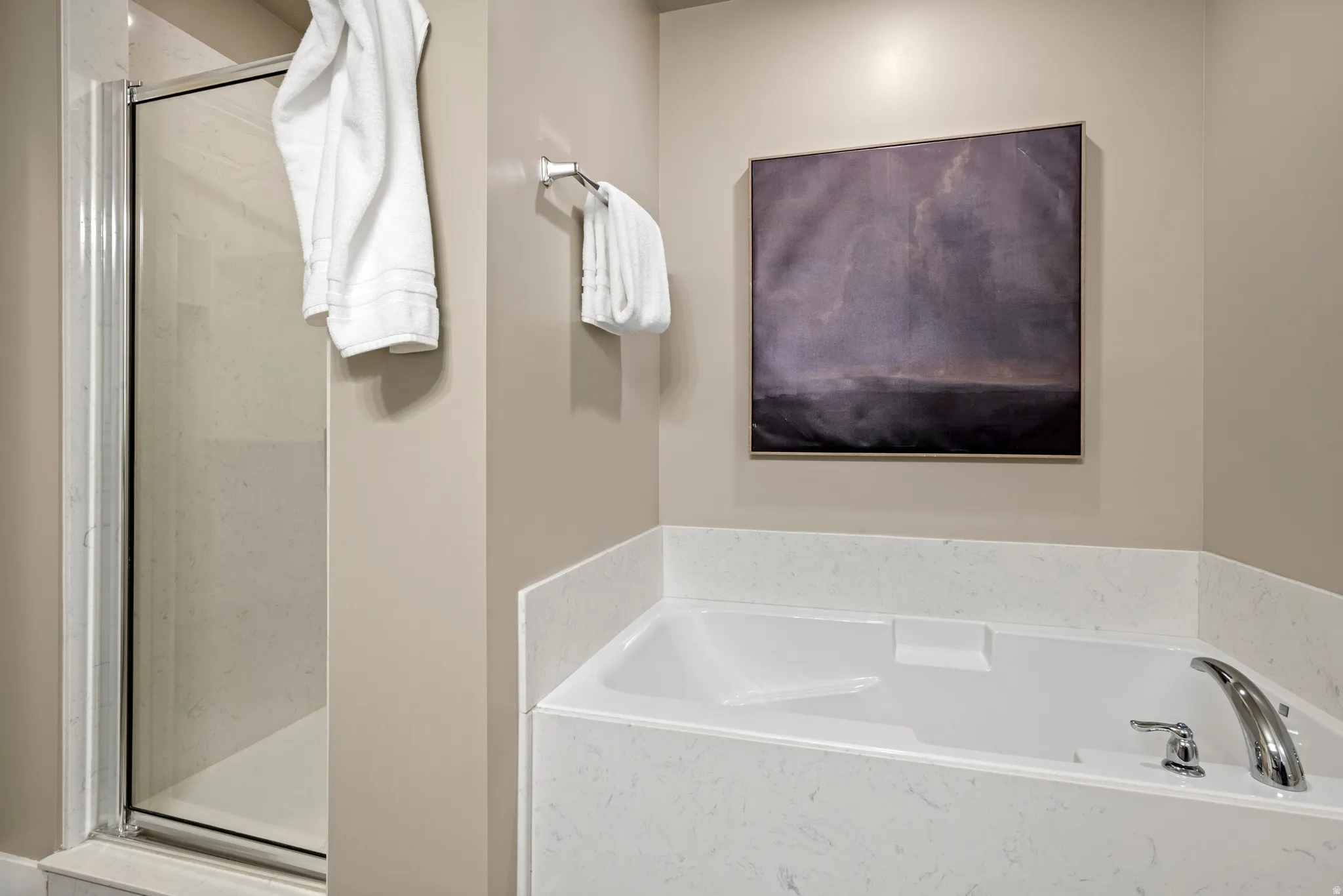 Soaking tub with a polished chrome faucet and white surround