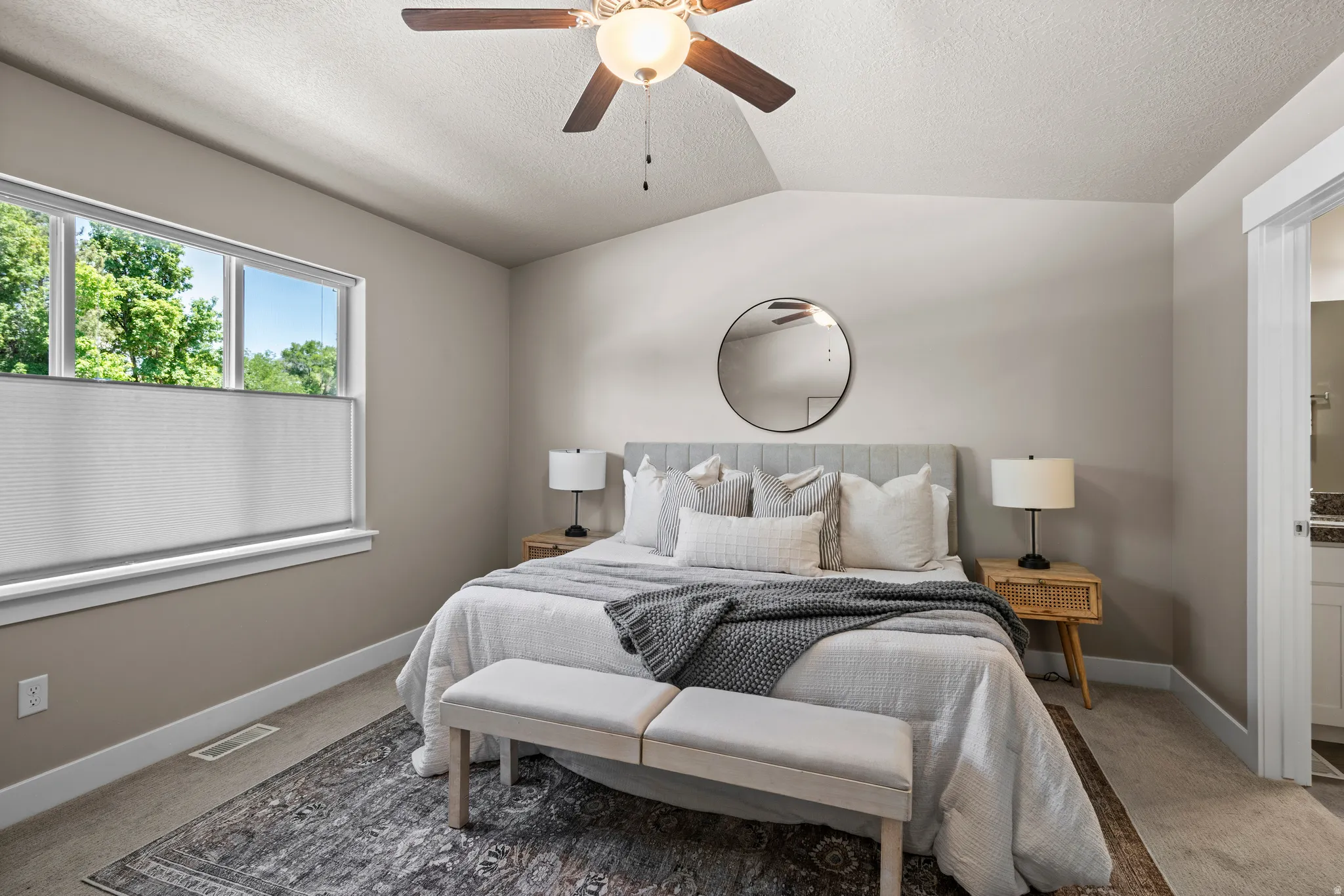 Vaulted ceiling featuring a ceiling fan with integrated lighting