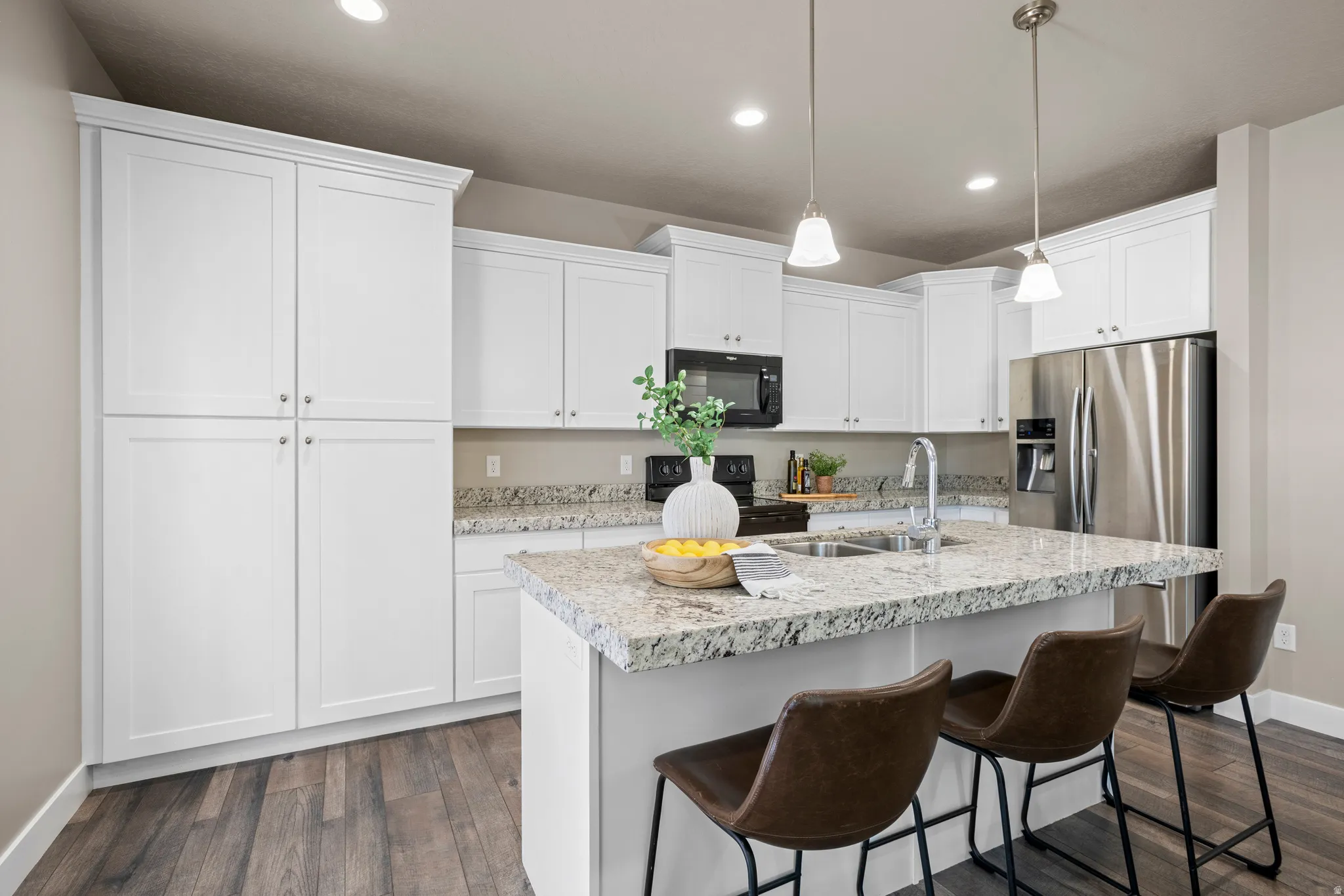 Modern kitchen with white cabinetry and granite countertops