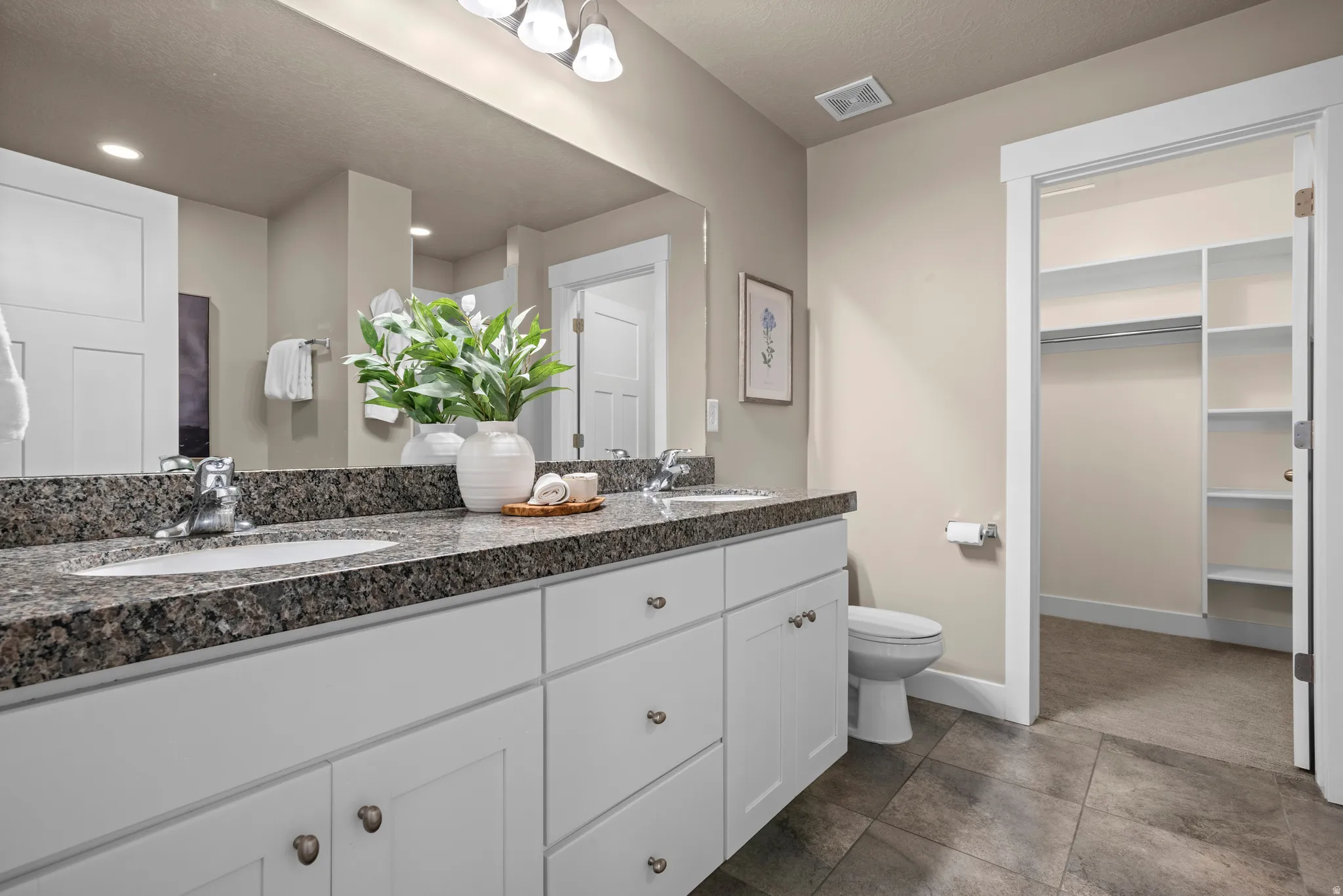 Double vanity with stone countertop and integrated sinks
