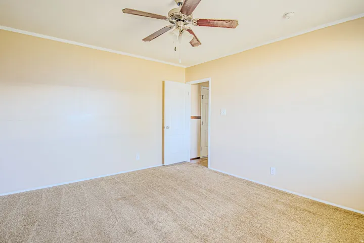 Neutral-toned walls complement the light beige carpet flooring