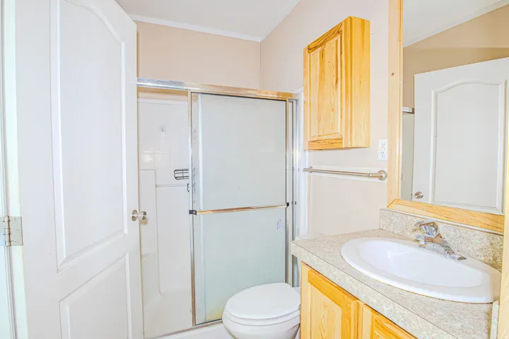 Bathroom featuring a vanity with an integrated sink, a wood-finish cabinet, and a mirrored medicine cabinet