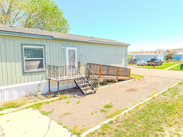 Light green siding exterior with white trim and a white foundation