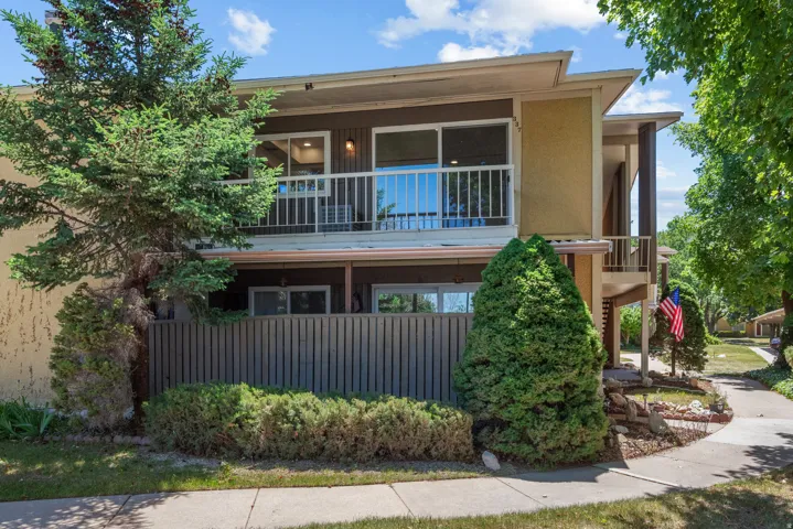 Two-story exterior with a second-level balcony featuring white railings. Unit is on second level.