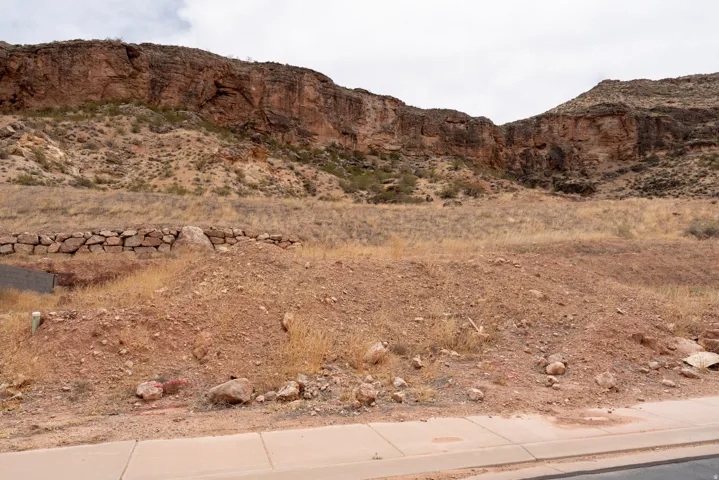 Expansive desert landscape with a prominent rock retaining wall